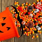 Pile of candy corn in a Halloween bucket, symbolizing unpopular treats