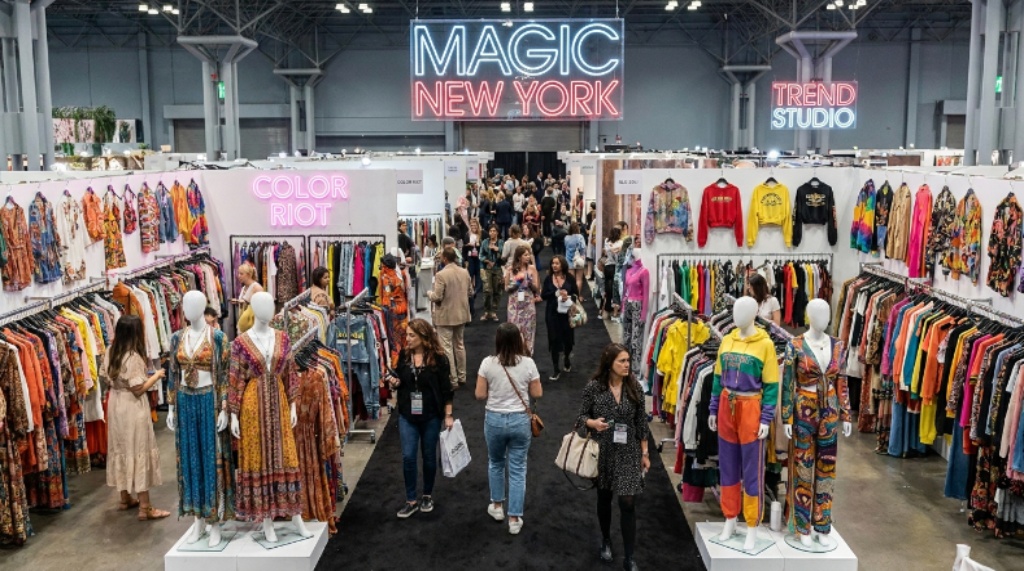 Colorful women's clothing displays and trend-forward collections on the show floor at MAGIC New York trade show in Manhattan