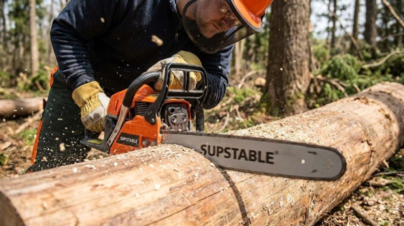 A sleek Supstable cordless chainsaw resting on a wooden workbench in a workshop.